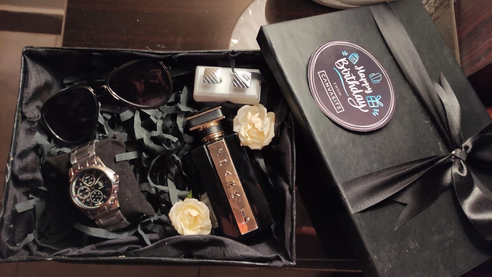 Watch, perfume and chocolates in a black box