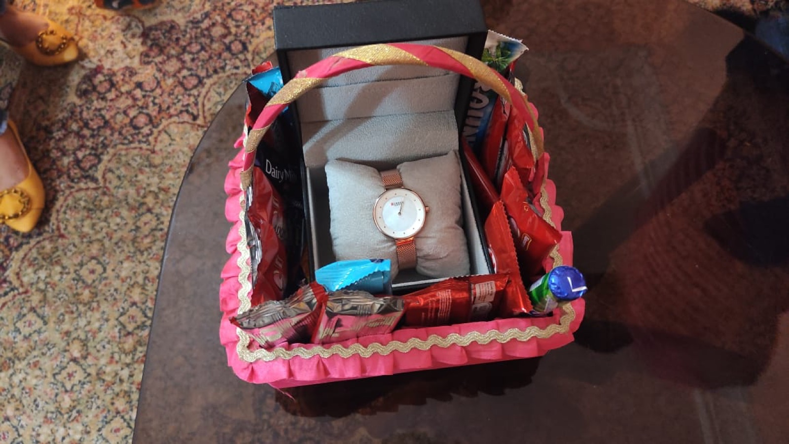 Basket with red ribbon and gift boxes
